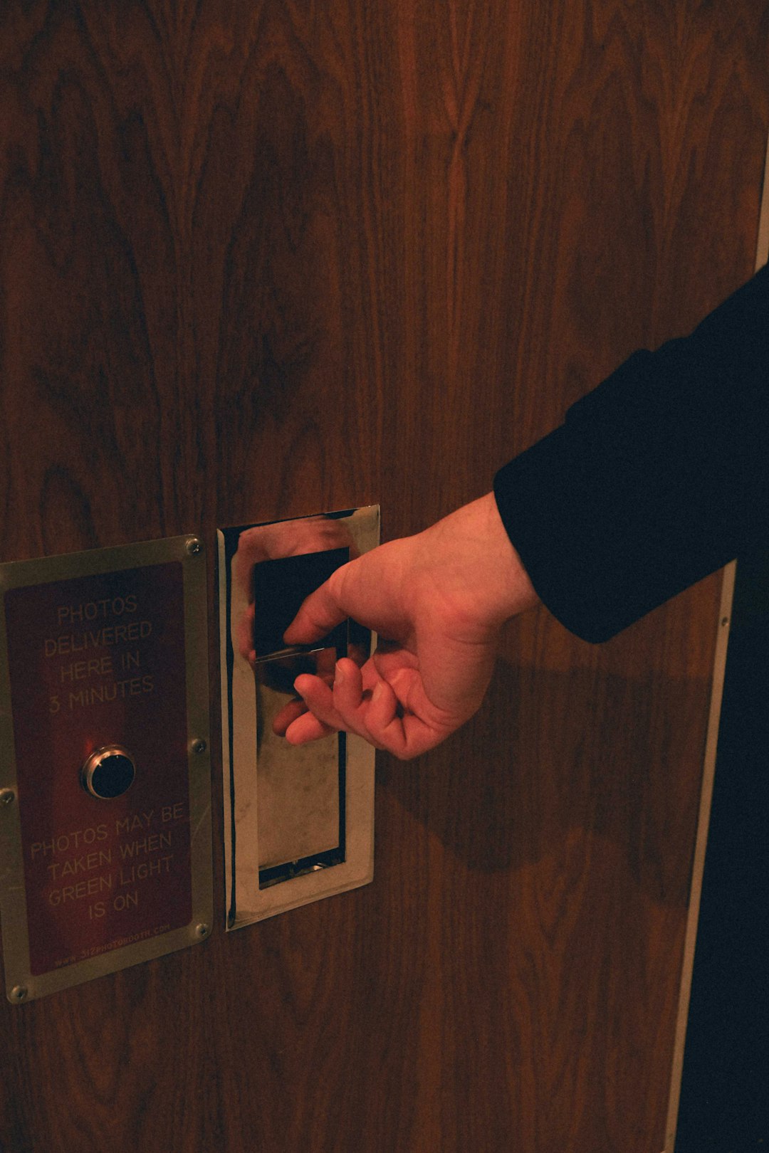 Hand securing a lock on a restricted access door